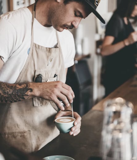 image of a man preparing a cup of coffee