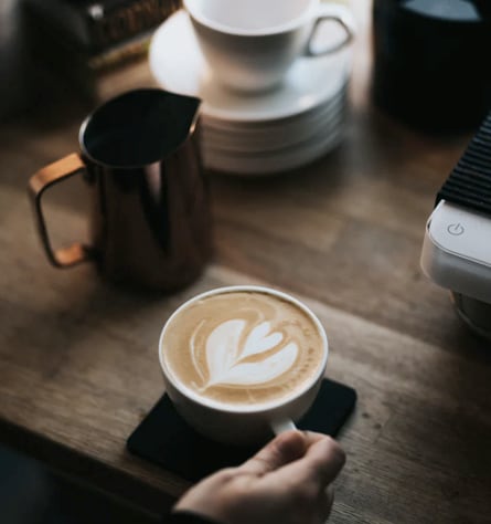 image of a person holding a cup of coffee